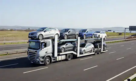 Multi-level car carrier on the motorway to St Helens, Merseyside, United Kingdom