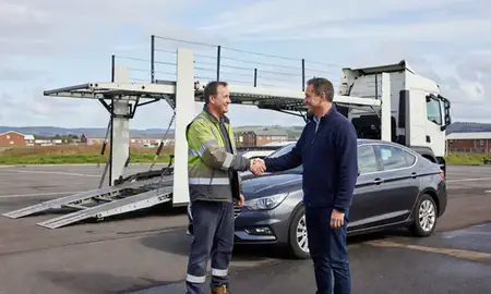 Vehicle owner beside their delivered car in Mid Glamorgan, United Kingdom