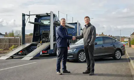 Vehicle owner beside their delivered car in Bridgend, Mid Glamorgan, United Kingdom