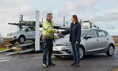 Vehicle owner beside their delivered car in Merthyr Tydfil, Mid Glamorgan, United Kingdom