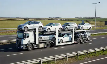 Multi-level car carrier on the motorway to Great Yarmouth, Norfolk, United Kingdom
