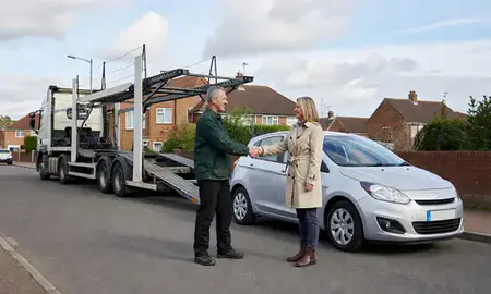 Vehicle owner beside their delivered car in Norwich, Norfolk, United Kingdom