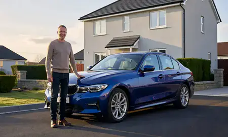 Customer with their delivered car in Airdrie, North Lanarkshire, United Kingdom