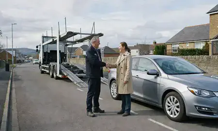 Vehicle owner beside their delivered car in Airdrie, North Lanarkshire, United Kingdom