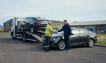 Vehicle owner beside their delivered car in Coatbridge, North Lanarkshire, United Kingdom