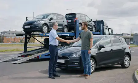 Vehicle owner beside their delivered car in Cumbernauld, North Lanarkshire, United Kingdom