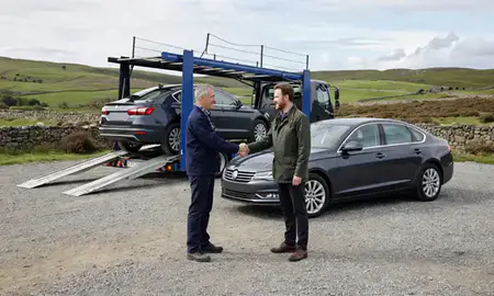 Vehicle owner beside their delivered car in Northumberland, United Kingdom