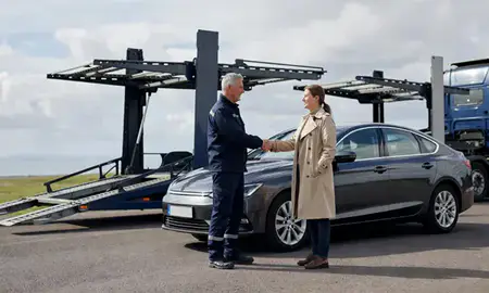 Vehicle owner beside their delivered car in Blyth, Northumberland, United Kingdom