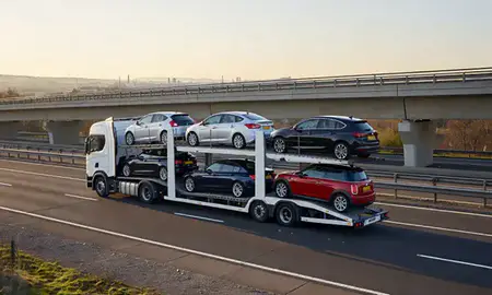 Car transporter with the Nottinghamshire, United Kingdom skyline behind it