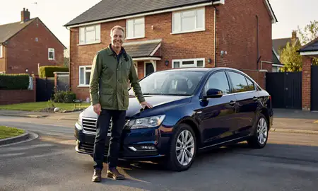 Customer with their delivered car in Beeston, Nottinghamshire, United Kingdom