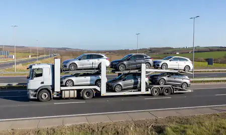 Multi-level car carrier on the motorway to Paisley, Renfrewshire, United Kingdom
