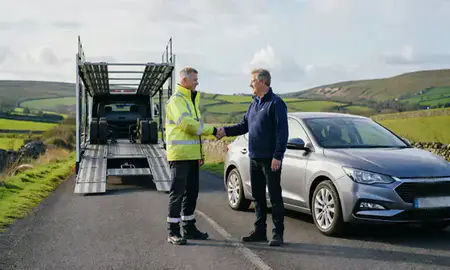Vehicle owner beside their delivered car in Shropshire, United Kingdom