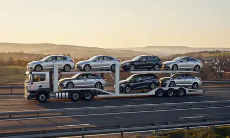 Car transporter with the Shropshire, United Kingdom skyline behind it