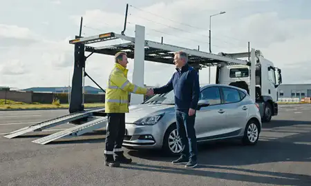 Vehicle owner beside their delivered car in Telford, Shropshire, United Kingdom