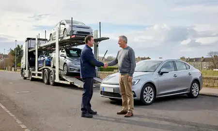 Vehicle owner beside their delivered car in Bath, Somerset, United Kingdom