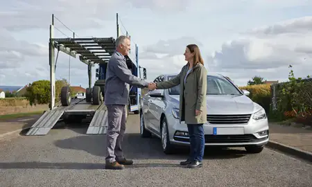 Vehicle owner beside their delivered car in Bridgwater, Somerset, United Kingdom