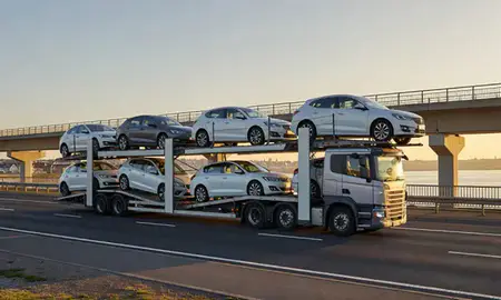 Car transporter with the Weston-super-Mare, Somerset, United Kingdom skyline behind it