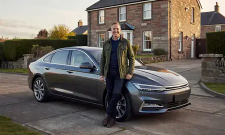 Customer with their delivered car in Ayr, South Ayrshire, United Kingdom