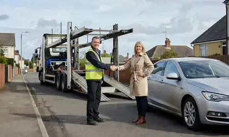 Vehicle owner beside their delivered car in Barry, South Glamorgan, United Kingdom