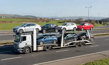 Multi-level car carrier on the motorway to Cardiff, South Glamorgan, United Kingdom