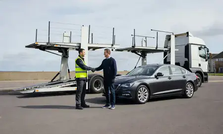 Vehicle owner beside their delivered car in Burton upon Trent, Staffordshire, United Kingdom