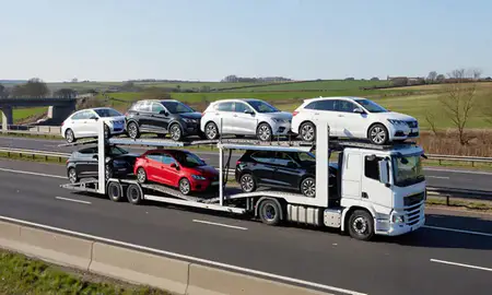Multi-level car carrier on the motorway to Bury St Edmunds, Suffolk, United Kingdom