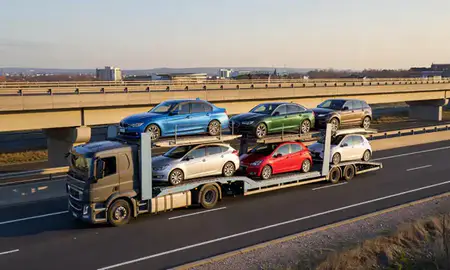 Car transporter with the Ipswich, Suffolk, United Kingdom skyline behind it