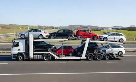 Multi-level car carrier on the motorway to Surrey, United Kingdom