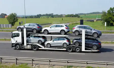 Multi-level car carrier on the motorway to Camberley, Surrey, United Kingdom