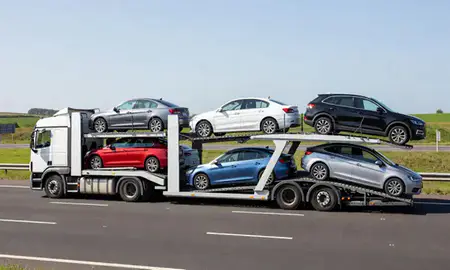 Multi-level car carrier on the motorway to Esher, Surrey, United Kingdom