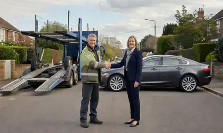 Vehicle owner beside their delivered car in Esher, Surrey, United Kingdom