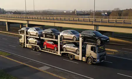 Car transporter with the Ewell, Surrey, United Kingdom skyline behind it