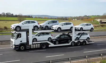 Multi-level car carrier on the motorway to Woking, Surrey, United Kingdom