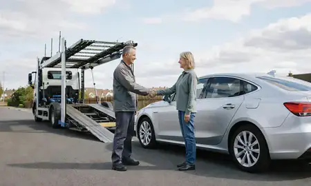 Vehicle owner beside their delivered car in Woking, Surrey, United Kingdom