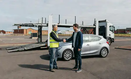 Vehicle owner beside their delivered car in Gateshead, Tyne and Wear, United Kingdom