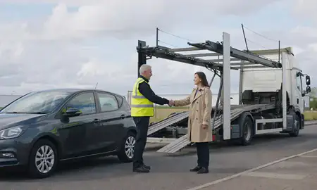 Vehicle owner beside their delivered car in Sunderland, Tyne and Wear, United Kingdom