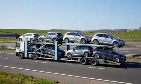 Multi-level car carrier on the motorway to Wallsend, Tyne and Wear, United Kingdom