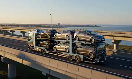Car transporter with the Whitley Bay, Tyne and Wear, United Kingdom skyline behind it
