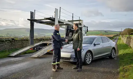 Vehicle owner beside their delivered car in Warwickshire, United Kingdom