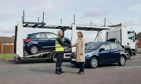 Vehicle owner beside their delivered car in Nuneaton, Warwickshire, United Kingdom