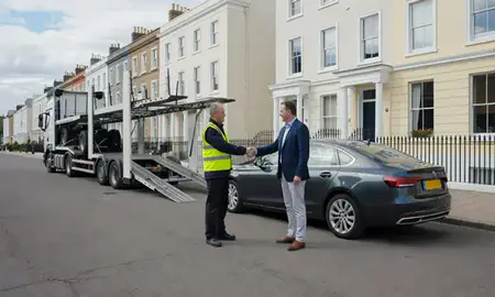 Vehicle owner beside their delivered car in Royal Leamington Spa, Warwickshire, United Kingdom