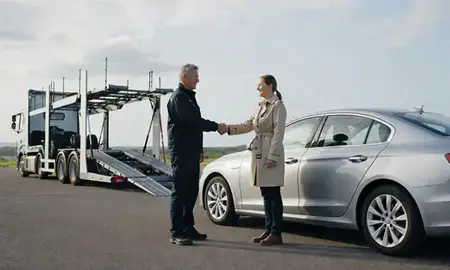 Vehicle owner beside their delivered car in West Glamorgan, United Kingdom