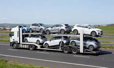 Multi-level car carrier on the motorway to Port Talbot, West Glamorgan, United Kingdom