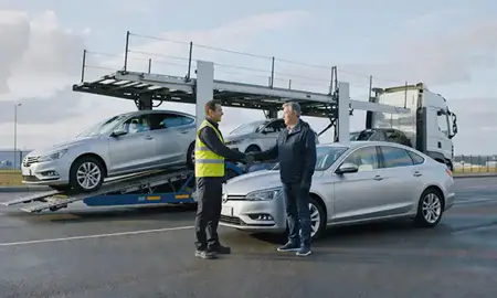 Vehicle owner beside their delivered car in Port Talbot, West Glamorgan, United Kingdom
