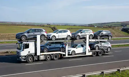 Multi-level car carrier on the motorway to Swansea, West Glamorgan, United Kingdom