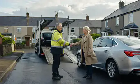 Vehicle owner beside their delivered car in Swansea, West Glamorgan, United Kingdom