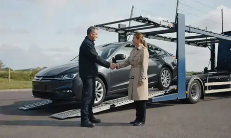 Vehicle owner beside their delivered car in West Lothian, United Kingdom