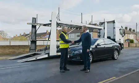 Vehicle owner beside their delivered car in West Midlands, United Kingdom
