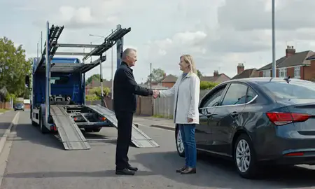 Vehicle owner beside their delivered car in Birmingham, West Midlands, United Kingdom