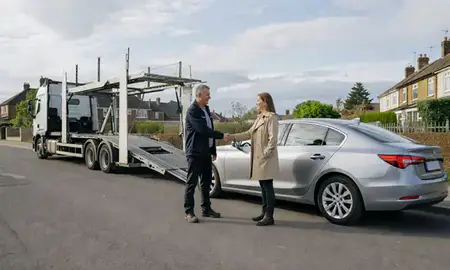 Vehicle owner beside their delivered car in Halesowen, West Midlands, United Kingdom